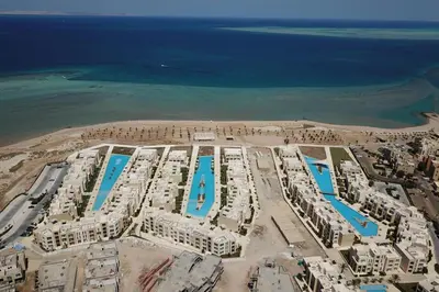 an aerial view of a resort near the ocean at Charming 2BDR w Sea & Pool View Free Beach & Pool Access in Hurghada