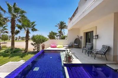 a swimming pool in the backyard of a house at Meditative & Blissful 2 BDR Villa Ancient Sands Private Pool in Hurghada