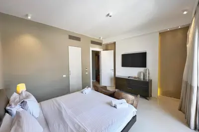 a hotel room with a bed and a television at Meditative & Blissful 2 BDR Villa Ancient Sands Private Pool in Hurghada