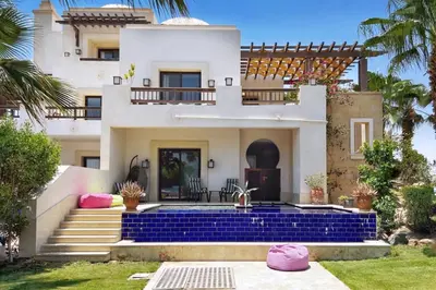 a villa with a blue staircase and a house at Meditative & Blissful 2 BDR Villa Ancient Sands Private Pool in Hurghada