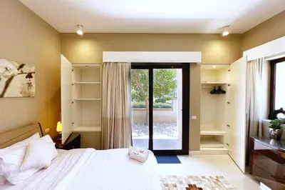 a bedroom with a bed and a sliding glass door at Meditative & Blissful 2 BDR Villa Ancient Sands Private Pool in Hurghada