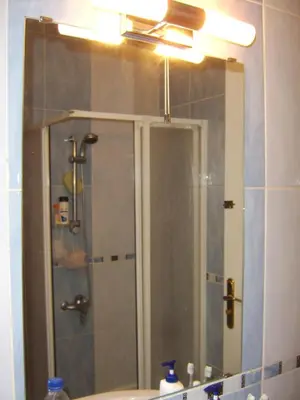 a bathroom mirror with a shower and a sink at A Beautiful, Family-owned Penthouse Apartment, Overlooking the Red Sea Hurghada in Hurghada