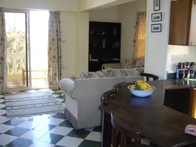 a living room with a couch and a bowl of fruit on a table at A Beautiful, Family-owned Penthouse Apartment, Overlooking the Red Sea Hurghada in Hurghada