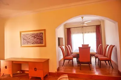 a dining room with a table and chairs at Sweet Rooms in Luxor