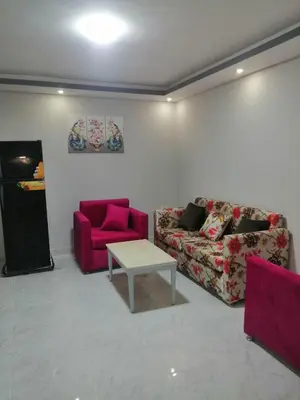 a living room with two couches and a table at 402 A in Hurghada