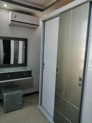 a bathroom with a tv and a sliding glass door at 402 A in Hurghada