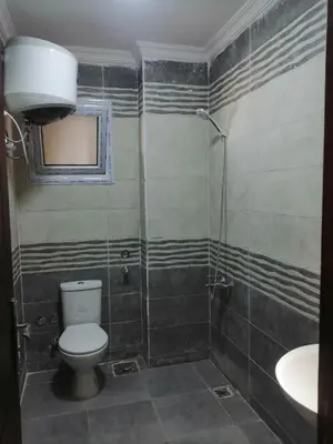 a bathroom with a toilet and a sink at 402 A in Hurghada