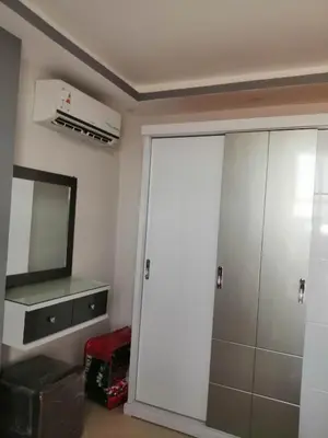 a bathroom with a closet with a mirror and a television at 403 A in Hurghada