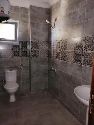a bathroom with a shower and a toilet and a sink at 403 A in Hurghada