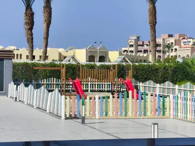 a fence with colorful books in front of a building at Scandic Resort Apartments in Hurghada