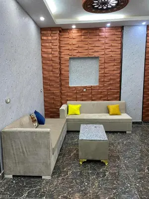 a living room with a couch and yellow pillows at Sunrise shiny Nubian Guest House in Aswan