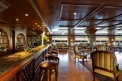 a bar in a restaurant with chairs and tables at Nile Cruise 3 nights From Aswan to Luxor Every Friday, Monday and Wednesday with tours in Jazīrat al ‘Awwāmīyah