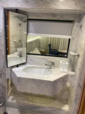 a bathroom with a sink and a large mirror at Nile Cruise 3 nights From Aswan to Luxor Every Friday, Monday and Wednesday with tours in Jazīrat al ‘Awwāmīyah