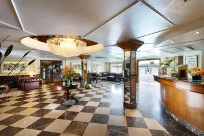 a lobby with a checkered floor and a chandelier at Nile Cruise 3 nights From Aswan to Luxor Every Friday, Monday and Wednesday with tours in Jazīrat al ‘Awwāmīyah