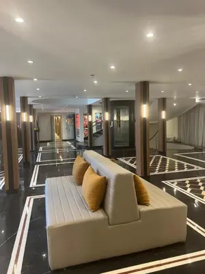 a white couch in the middle of a lobby at Nile Cruise 5 Stars From Luxor And Aswan 3&4 Nights in Aḑ Ḑab‘īyah