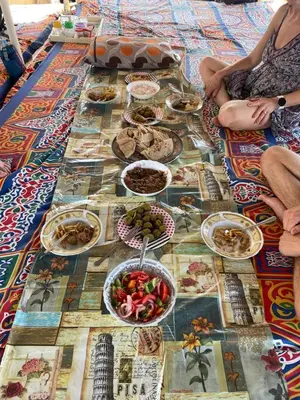 a table with many plates of food on it at Kayan Guest House in Aswan