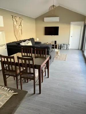 a living room with a couch and a table and chairs at 2 Bedroom villa with private heated pool in Gouna in Hurghada