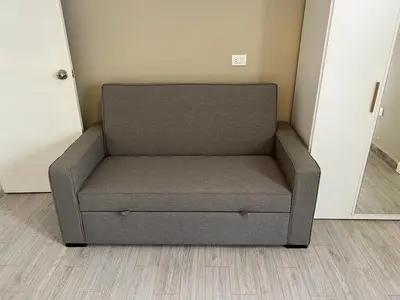 a gray couch sitting in a corner of a room at 2 Bedroom villa with private heated pool in Gouna in Hurghada