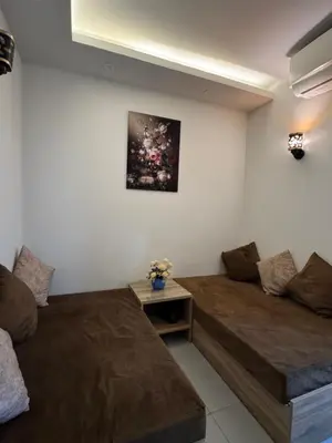 a living room with two beds and a couch at Scandic Rezort in Hurghada