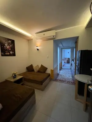 a living room with two beds and a couch at Scandic Rezort in Hurghada