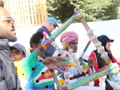a group of people playing with a bamboo pole at Torya Nubian House in Aswan
