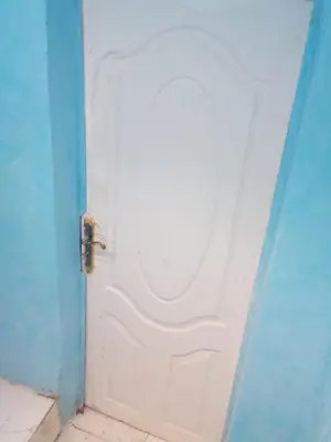 an open white door in a blue room at Rose house in Aswan