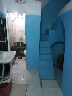a bathroom with a blue staircase with a sink at Rose house in Aswan