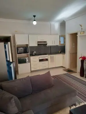 a living room with a couch and a kitchen at Hurghada Red Sea in Hurghada