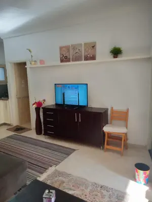 a living room with a tv and a chair at Hurghada Red Sea in Hurghada