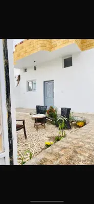 a patio with two chairs and a bench in a building at Hadi Guest House in Luxor