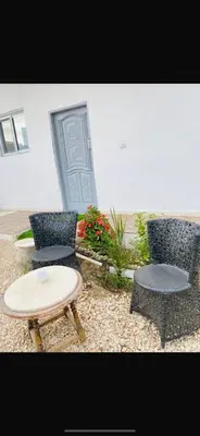 two chairs and a table and two chairs and a door at Hadi Guest House in Luxor