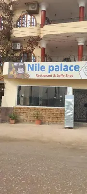 a nine palace restaurant and coffee shop sign in front of a building at Nile View Panoramique and Garden West bank in Luxor