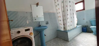 a bathroom with a washing machine and a toilet at Nile View Panoramique and Garden West bank in Luxor