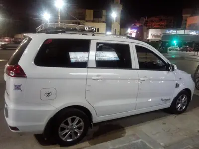 a white car parked on a street at night at Aswan City Center Guest House in Aswan