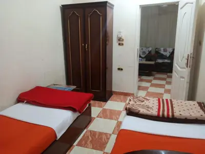 a small room with two beds and a closet at Aswan City Center Guest House in Aswan