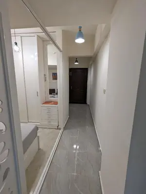 a room with a hallway with a bed and a mirror at fully finished, very cozy and comfortable studio -Marina city Residence in Port Ghalib