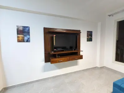 a living room with a flat screen tv on a wall at fully finished, very cozy and comfortable studio -Marina city Residence in Port Ghalib