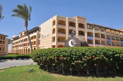 a large building with a sign in front of it at fully finished, very cozy and comfortable studio -Marina city Residence in Port Ghalib