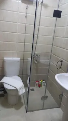 a bathroom with a shower and a toilet and a sink at Tropical 1 bed apartment in Hurghada