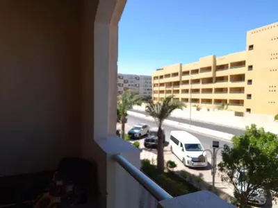 a balcony with a view of a parking lot with cars at Florenza khamsin aprt F7 in Hurghada