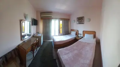 a living room with two beds and a window at New Pola Hotel in Luxor