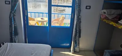 a blue door in a room with a balcony at Airkela Nuba Dool 2 in Aswan