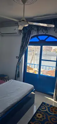 a bedroom with a bed and a window on a boat at Airkela Nuba Dool 2 in Aswan