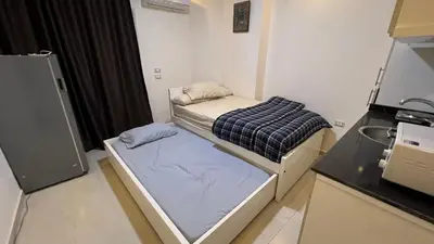 a small room with a bed and a microwave at Casablanca beach resort, first line, with private beach and swimming pools,hurghada in Hurghada