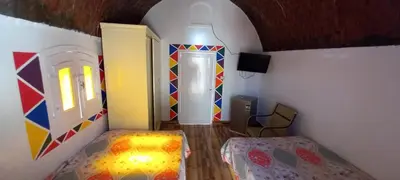 a room with a bedroom with a bed and a mirror at Casablanca Guest House in Aswan