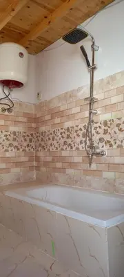 a bath tub with a shower in a bathroom at Casablanca Guest House in Aswan