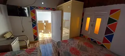 a bedroom with a bed and a colorful wall at Casablanca Guest House in Aswan