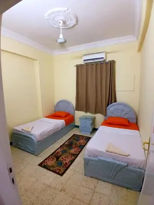 a room with two beds and a window at Gamal Robob Nubian Guest House in Aswan