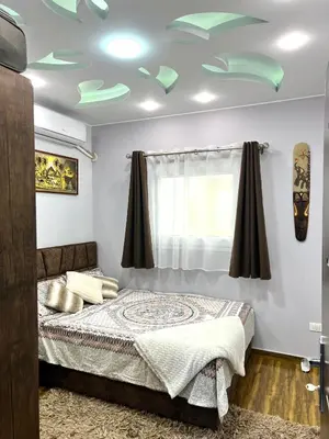 a bedroom with a bed and a green ceiling at GRACELAND Apartment in Hurghada city centre in Hurghada