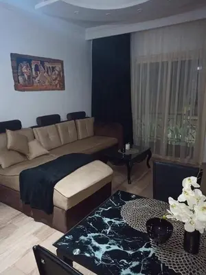 a living room with a couch and a table at Alena Lempachova in Hurghada